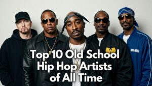Group portrait of iconic old school hip hop legends standing together against a plain white wall: Eminem, Dr. Dre, Tupac Shakur, Snoop Dogg, and members of Wu-Tang Clan (including RZA, Method Man, and others), all wearing classic 90s rap fashion with gold chains, leather jackets, snapbacks, bandanas, and sunglasses. Bold white text overlay reads "Top 10 Old School Hip Hop Artists of All Time